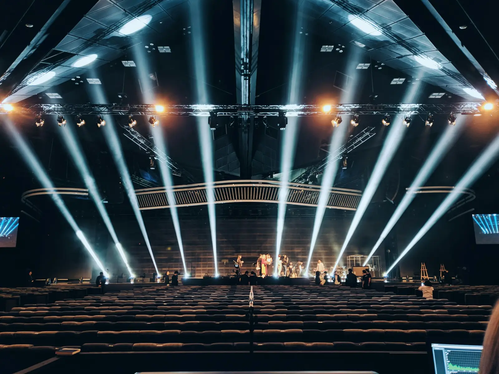 Stage lighting beams over an empty auditorium